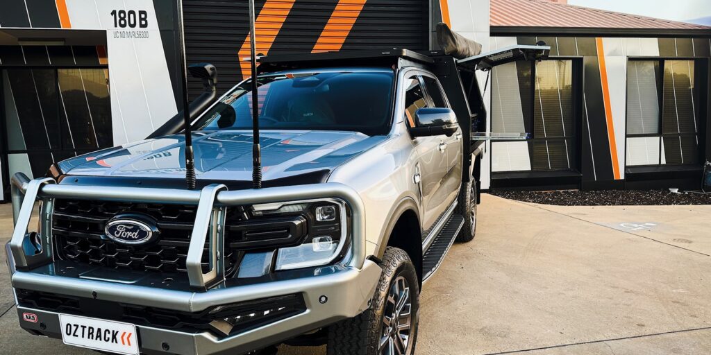 Silver 2023 Ford Ranger Wildtrak with an OzTrack V1-CM200 chassis-mount canopy