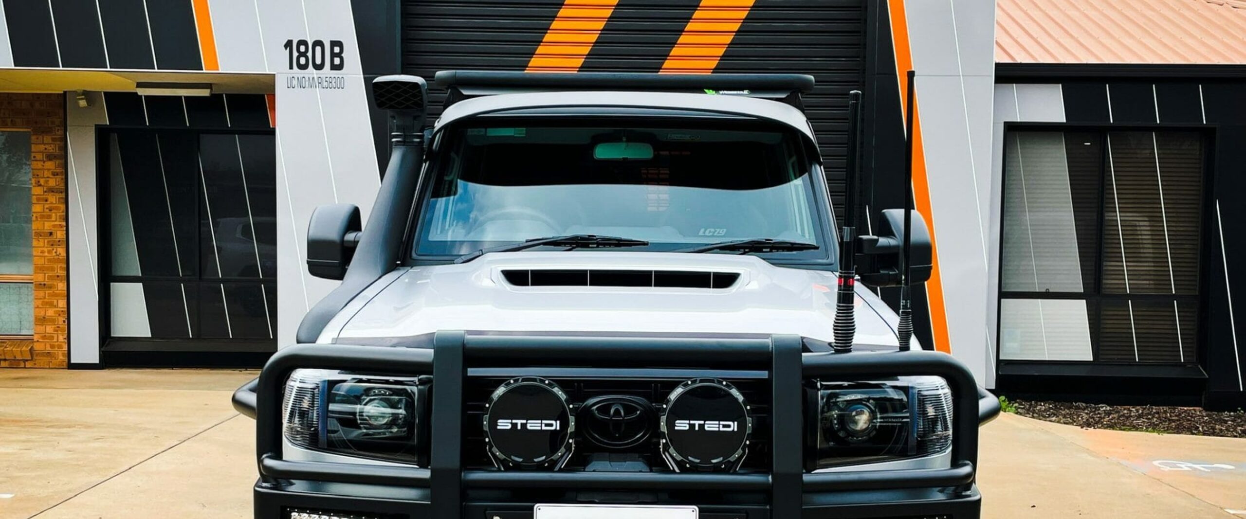A custom-built LandCruiser 79 Series outside the OzTrack Custom workshop in Griffith